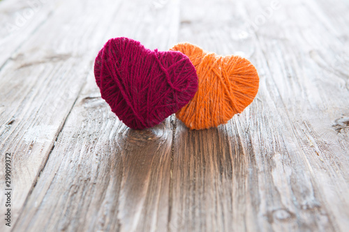 Fototapeta Two heart shape of yarn on vintage wooden background