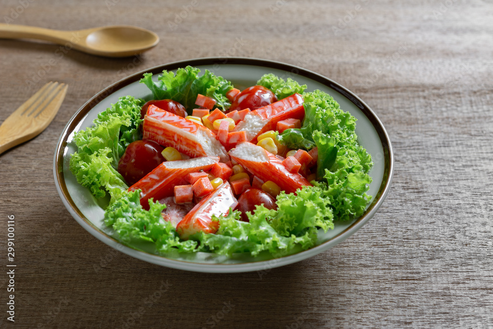 close up of crab stick salad in a ceramic dish on wooden table. homemade style healthy food concept. close up of crab stick salad in a ceramic dish on wooden table. homemade style healthy food concept.