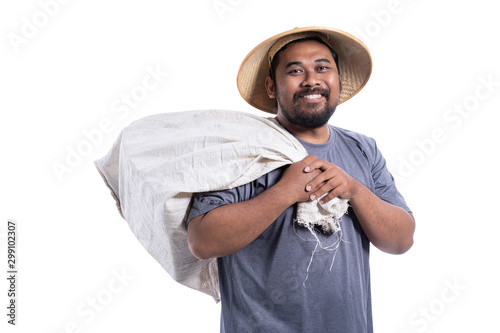 portrait of smiling scrap collector or junkman holding a bag of scrap photo
