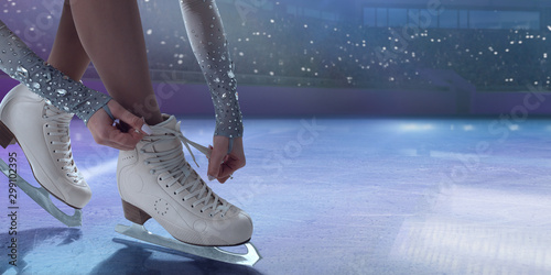 Fototapeta Figure skating girl in ice arena.