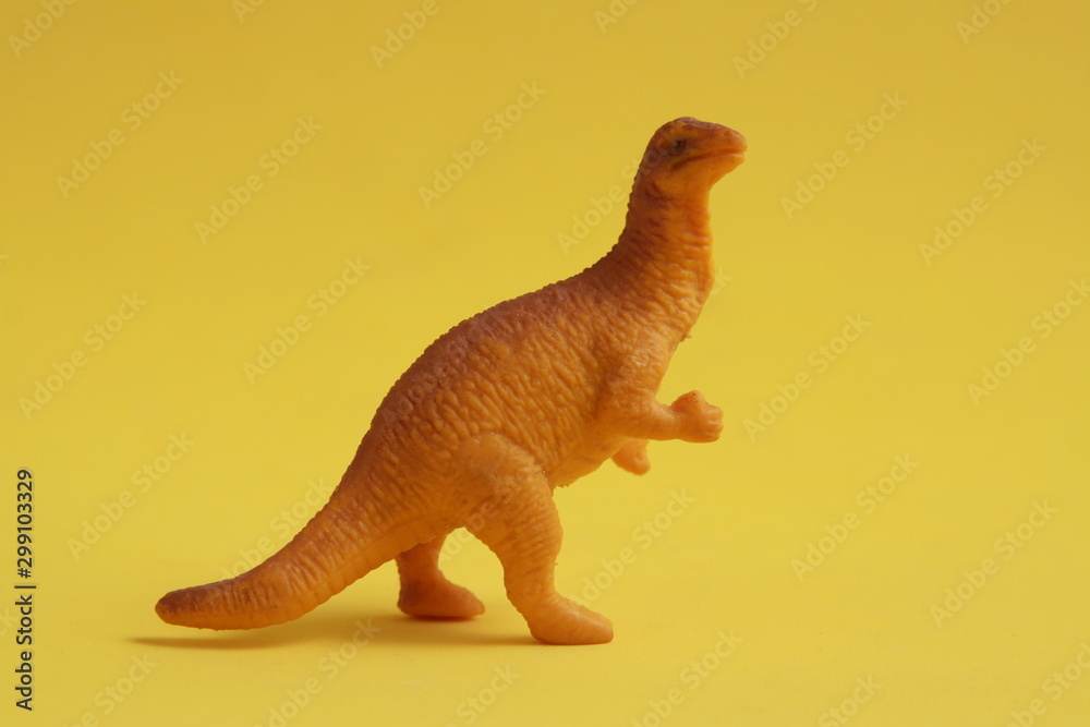 plastic toy with dinosaur shape in color background