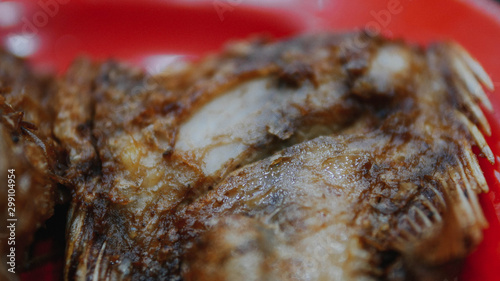 fried carp on a red plate photo
