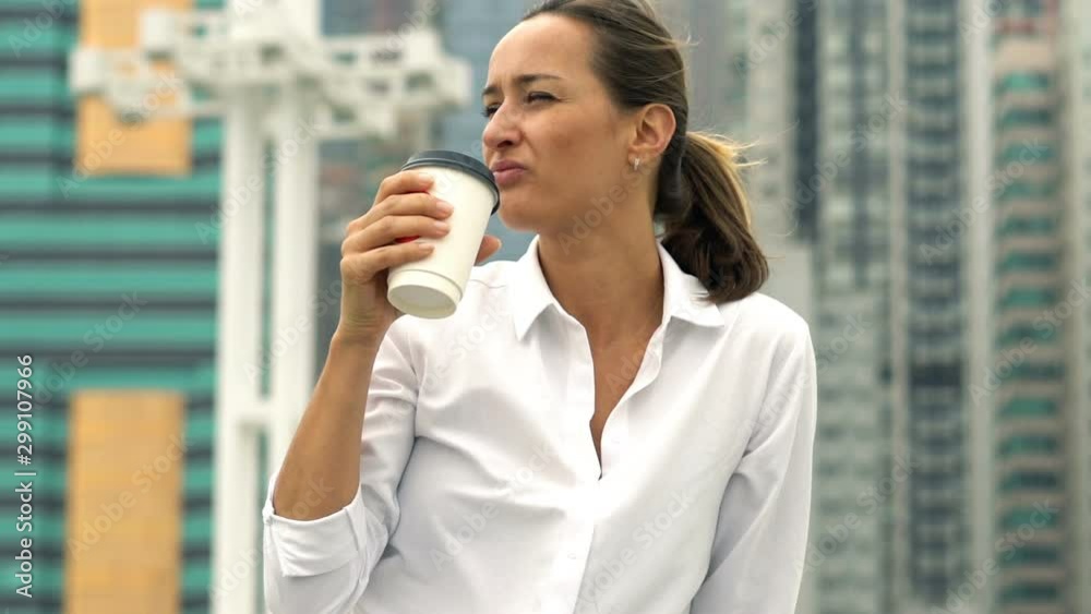 Pretty businesswoman drinking coffee and relaxing in city Pretty businesswoman drinking coffee and relaxing in city