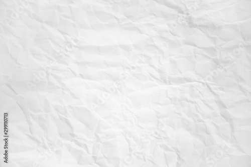 white and gray wide crumpled paper texture background. crush paper so that it becomes creased and wrinkled.