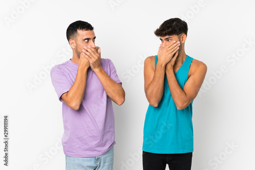 Two men over isolated background covering mouth with hands for saying something inappropriate