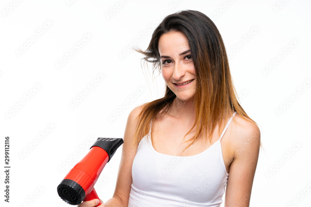 Young woman with hairdryer over isolated background Young woman with hairdryer over isolated background