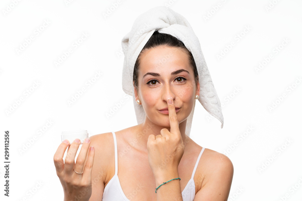 Young woman with moisturizer over isolated white background Young woman with moisturizer over isolated white background
