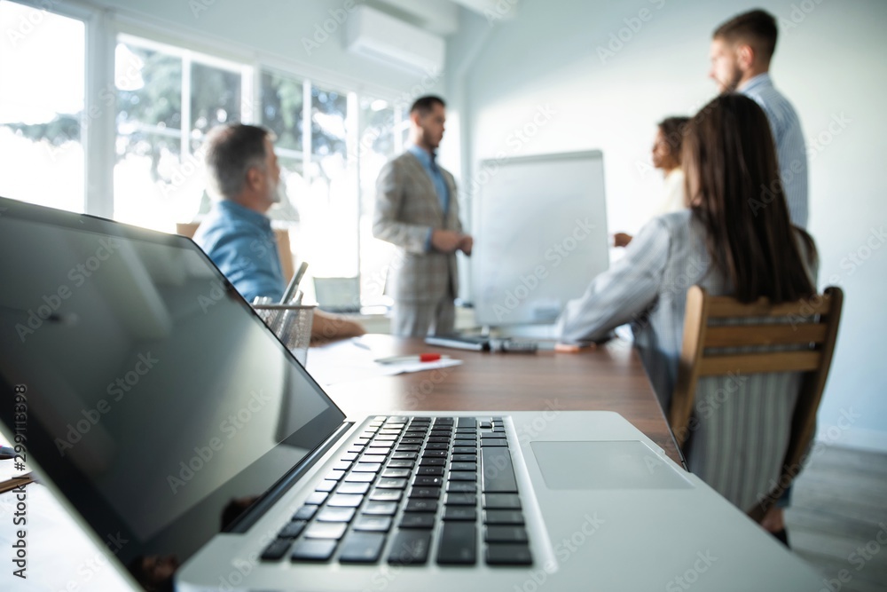 Business man making a presentation at office. Business executive delivering a presentation to his colleagues Business man making a presentation at office. Business executive delivering a presentation to his colleagues