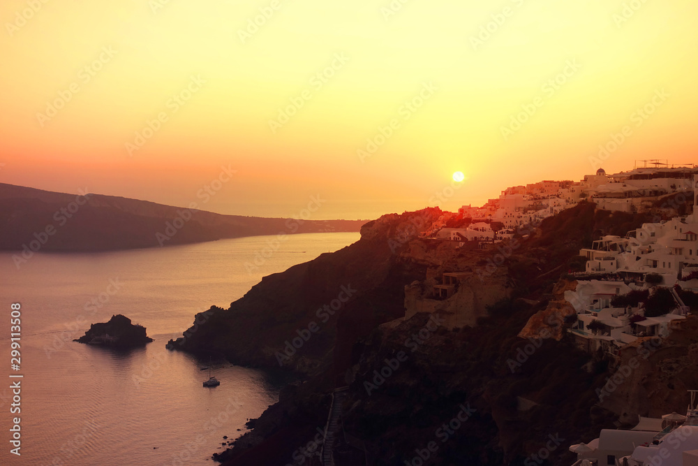 Sunset over beautiful traditional village of Oia, Santorini island, Cyclades, Greece