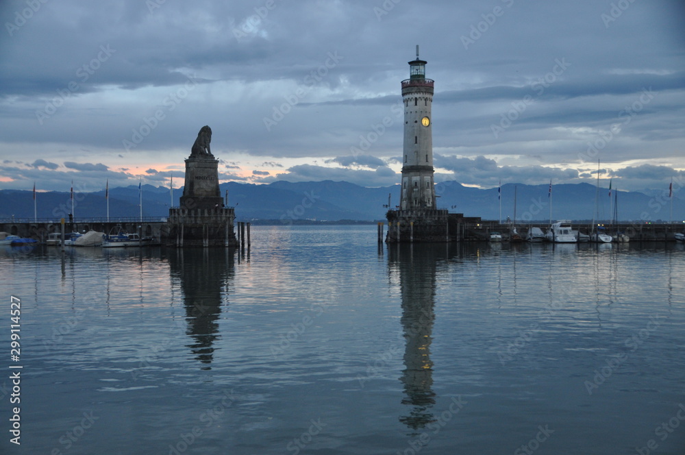 the Bavarian lion and the ligthouse at the entrance of Lindau harbor, Lake Constance, Bavaria, Germany