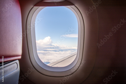  Looking at the view through the plane window, saw a group of white clouds. © Tushchakorn