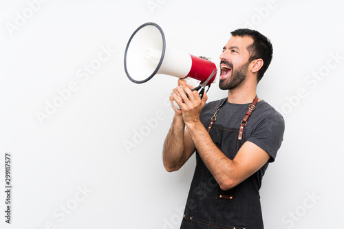 Barber man in an apron shouting through a megaphone