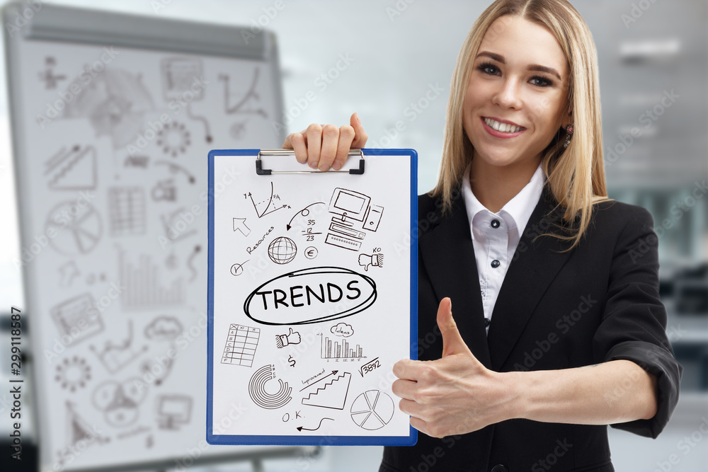 Business, technology, internet and network concept. Young businessman shows a key phrase: Trends Business, technology, internet and network concept. Young businessman shows a key phrase: Trends