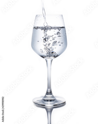 A glass of wine pouring water on a white background