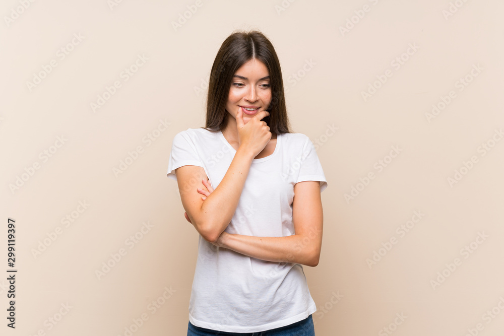 Pretty young girl over isolated background looking to the side Pretty young girl over isolated background looking to the side