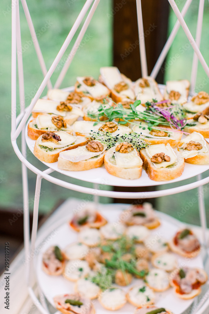 Mini canapes food. Beautiful decorated catering banquet, wooden stands.  Snacks and appetizers. Wedding celebration Stock Photo | Adobe Stock