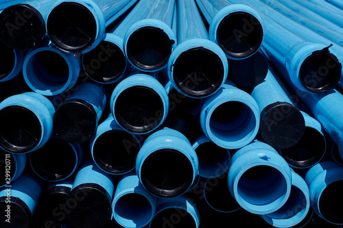 A pile of water pvc pipes places outside under sun light. Each water pipe has radius of 4 inches.