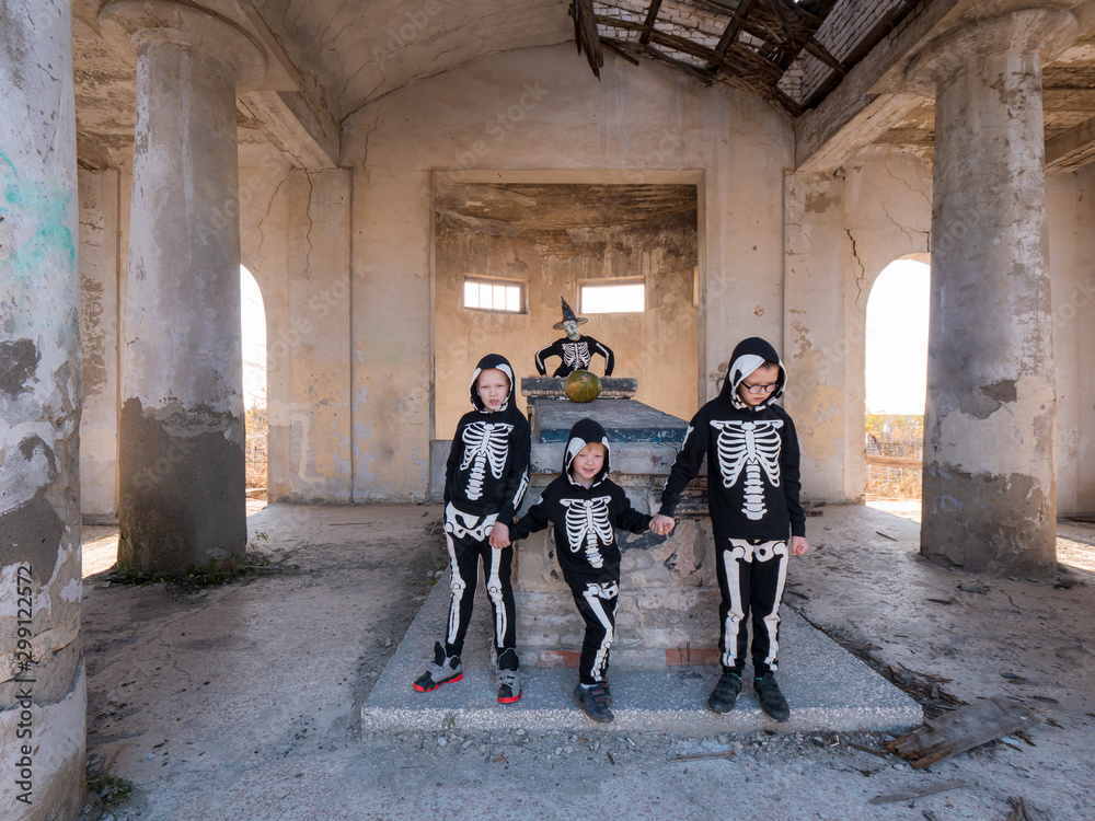 Children and their mother in carnival costumes celebrate Halloween in ...