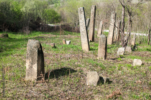 Scene of old abandoned Muslim cemetery tombstones in countryside field