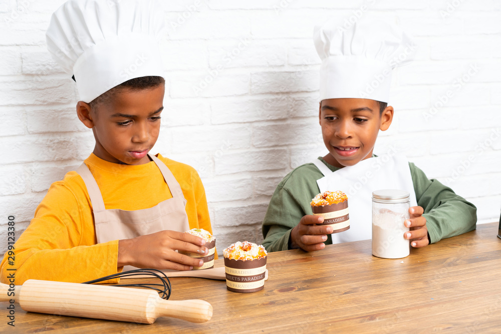 Two African American brothers kids dressed as chef Two African American brothers kids dressed as chef