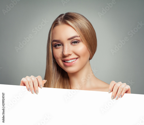 Pretty woman with clear skin holding empty white card singboard