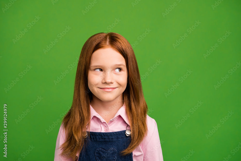 Closeup photo of little ginger schoolchild in front of blackboard looking empty space thinking over answer teacher question wear denim overall pink shirt isolated green background Closeup photo of little ginger schoolchild in front of blackboard looking empty space thinking over answer teacher question wear denim overall pink shirt isolated green background