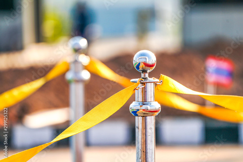 luxury stainless barricade with yellow rope ribbon on the road in Marathon event at the finish point. photo