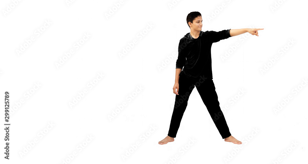 Full-length shot of male energetic young teenager isolated on white  background pointing on one side with hand stretched out. Male active pose.  A sporty boy in sportswear. Full body pose. Photos