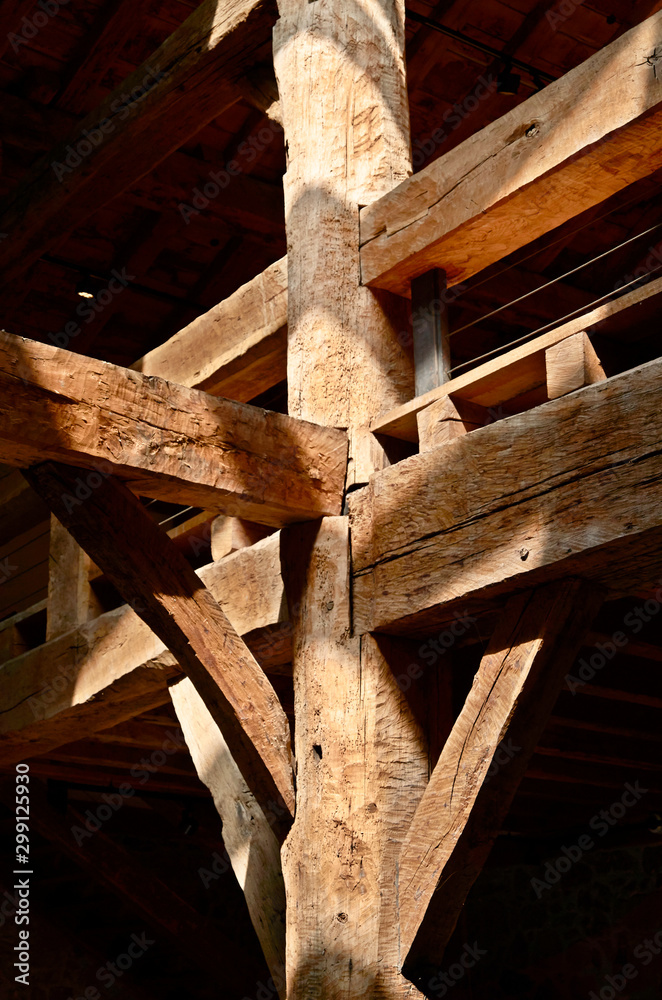 large wooden beams in an old building with sunlight rays large wooden beams in an old building with sunlight rays