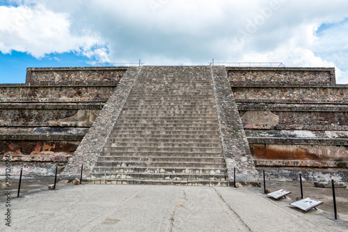 Architectural details of the walls of significant Mesoamerican pyramids and green grassland located at at Teotihuacan, an ancient Mesoamerican city located in a sub-valley of the Valley of Mexico