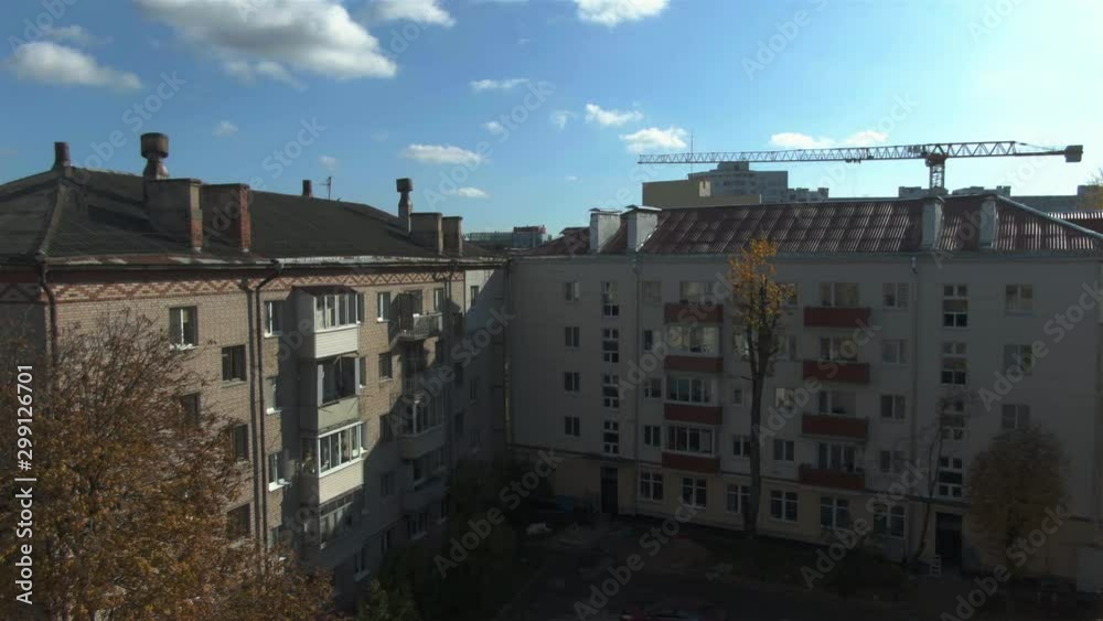 Old houses. Construction of the times of the USSR. House. Russia. Brick multi-storey building. Green trees. Beginning of autumn. Old houses. Construction of the times of the USSR. House. Russia. Brick multi-storey building. Green trees. Beginning of autumn.