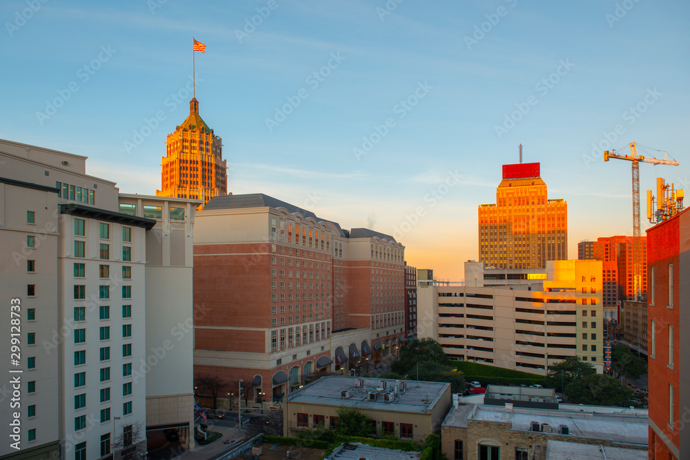 Obraz premium San Antonio city skyline including Hotel Contessa, Westing Riverwalk, Drury Plaza Hotel and Tower Life Building at sunrise in downtown San Antonio, Texas, USA.
