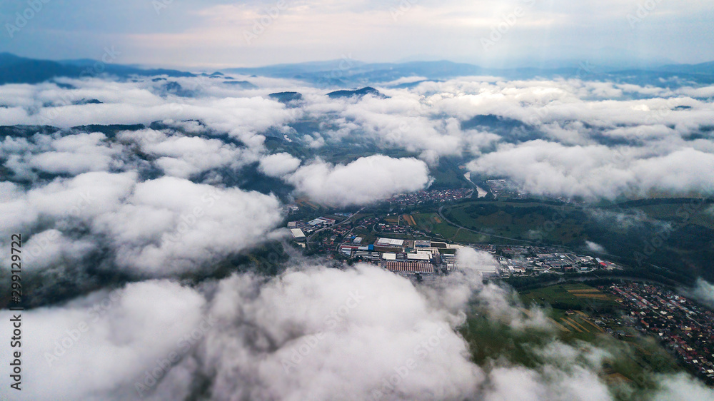Aerial view through clouds to the city of Dolny Kubin