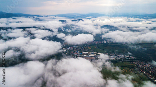 Aerial view through clouds to the city of Dolny Kubin