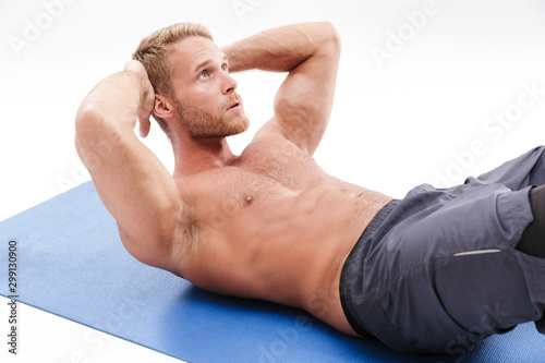 Confident attractive sportsman doing core exercise