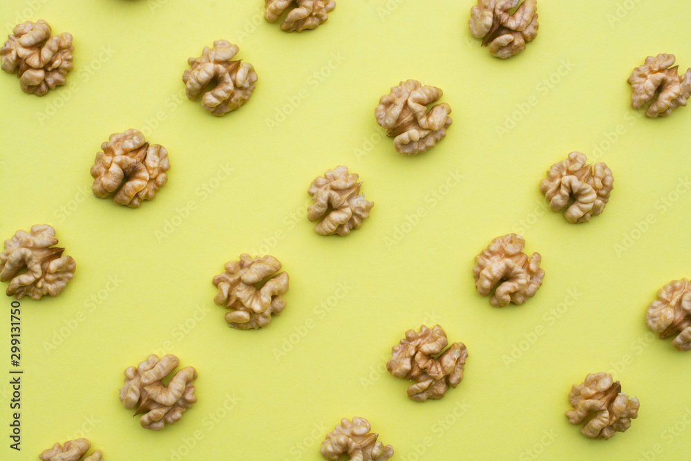 Grains of walnut on a yellow background. Grains of walnut on a yellow background.