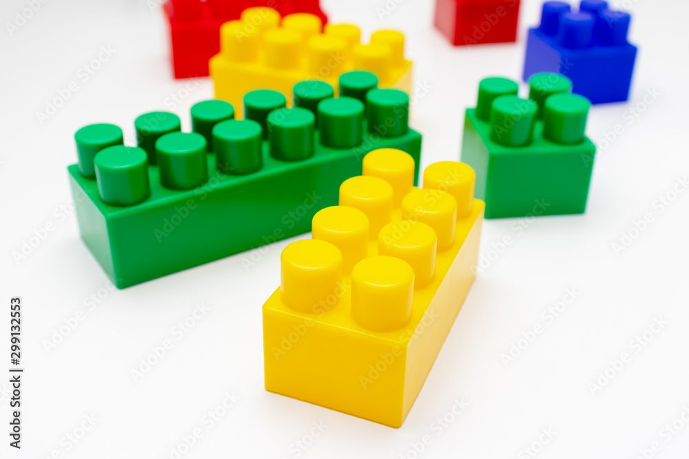 Many colorful toy plastic bricks, kit of blocks for building and constructing on white background, Children's game and playing concept Many colorful toy plastic bricks, kit of blocks for building and constructing on white background, Children's game and playing concept
