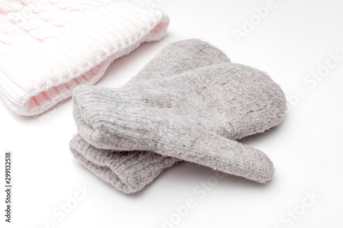 Knitted hat and warm winter mittens on white background, winter sport concept
