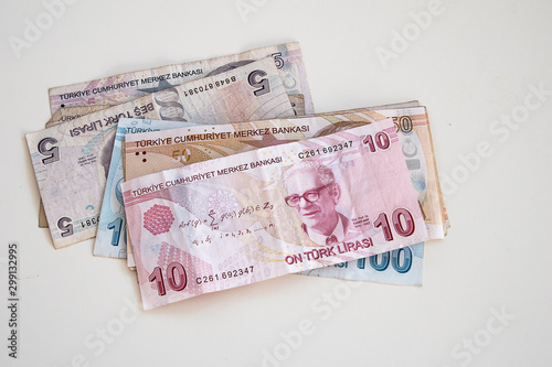  Turkish paper banknotes lying on a white table