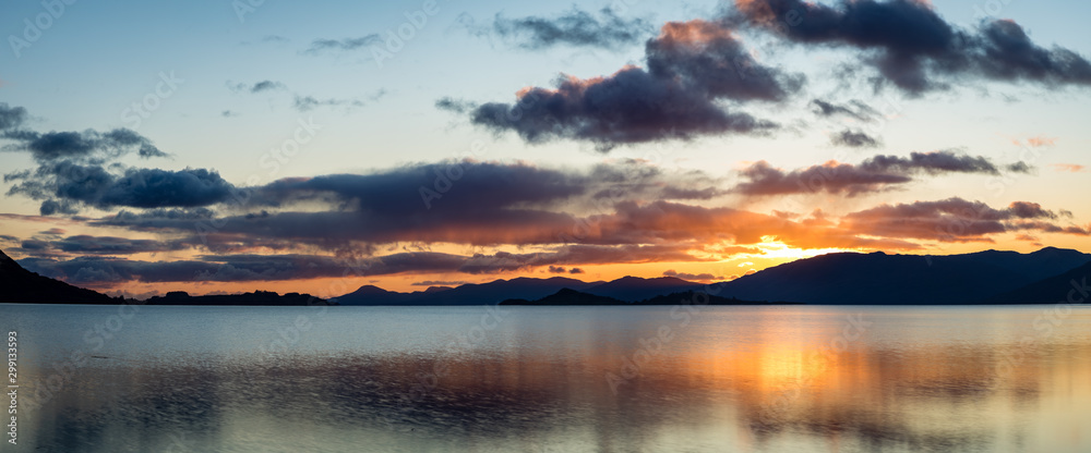 Fototapeta premium golden light on loch linnhe in the argyll region of the highlands of scotland in an autumn golden sunset