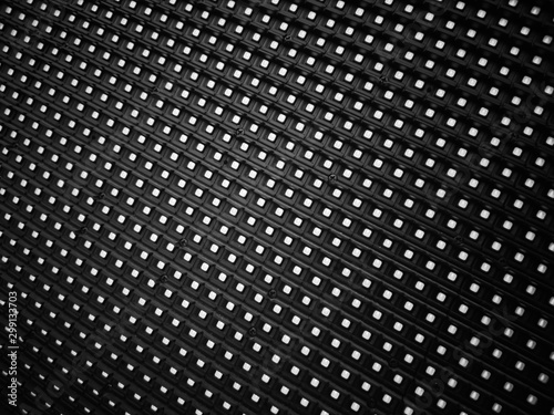 Abstract black and white tone background of led lights diagonal stripes and grids pattern.