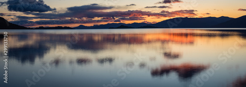 loch linnhe in the argyll region of the highlands of scotland during an autumn sunset showing golden light on the clouds and water and the islands of lismore and shuna photo