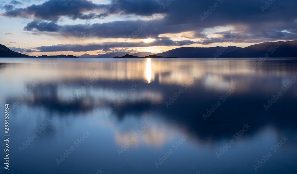 loch linnhe in the argyll region of the highlands of scotland during an autumn sunset showing golden light on the clouds and water and the islands of lismore and shuna loch linnhe in the argyll region of the highlands of scotland during an autumn sunset showing golden light on the clouds and water and the islands of lismore and shuna