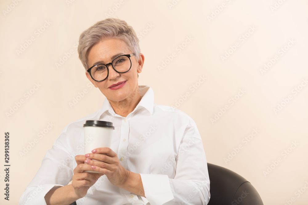 stylish beautiful woman with a short haircut, in a white shirt on a beige background stylish beautiful woman with a short haircut, in a white shirt on a beige background