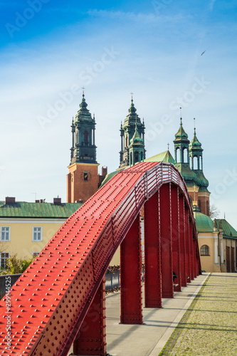 View of the red bridge and the Cathedral of Saints Peter and Paul in the Polish city of Poznan