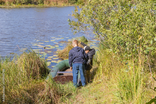 Children prepare an inflatable boat for launching