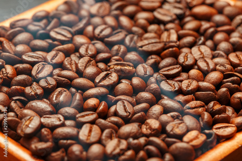 Fresh and aromatic roasted coffee beans in two wooden box  can be used as background.