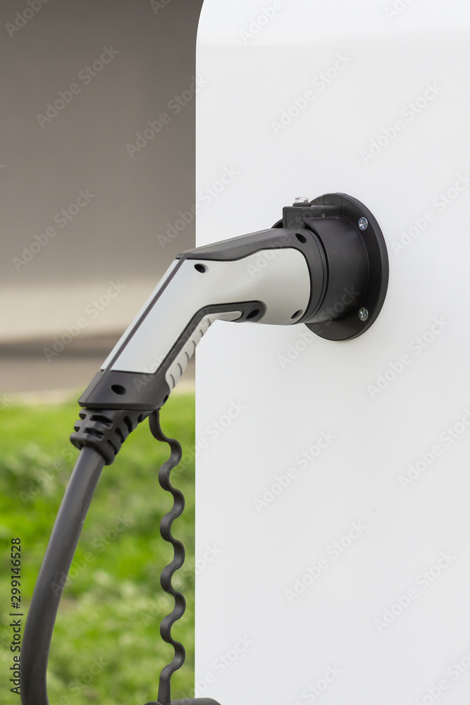 Modern electrical fast charger to hybrid automobiles. High technology charger for green way of driving PHEV. Ecology friendly charger. New generation of environmental friendly green petrol station.