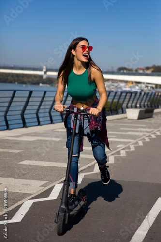 Pretty young woman riding a...