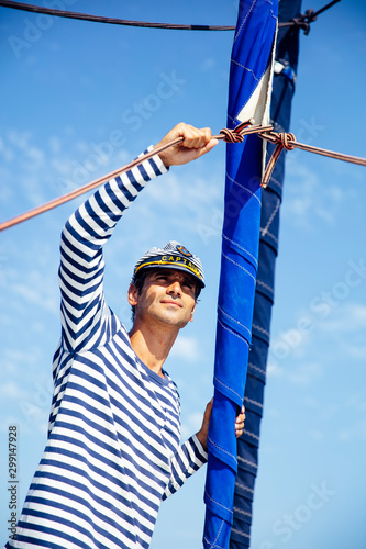 Handsome young man on a sai...